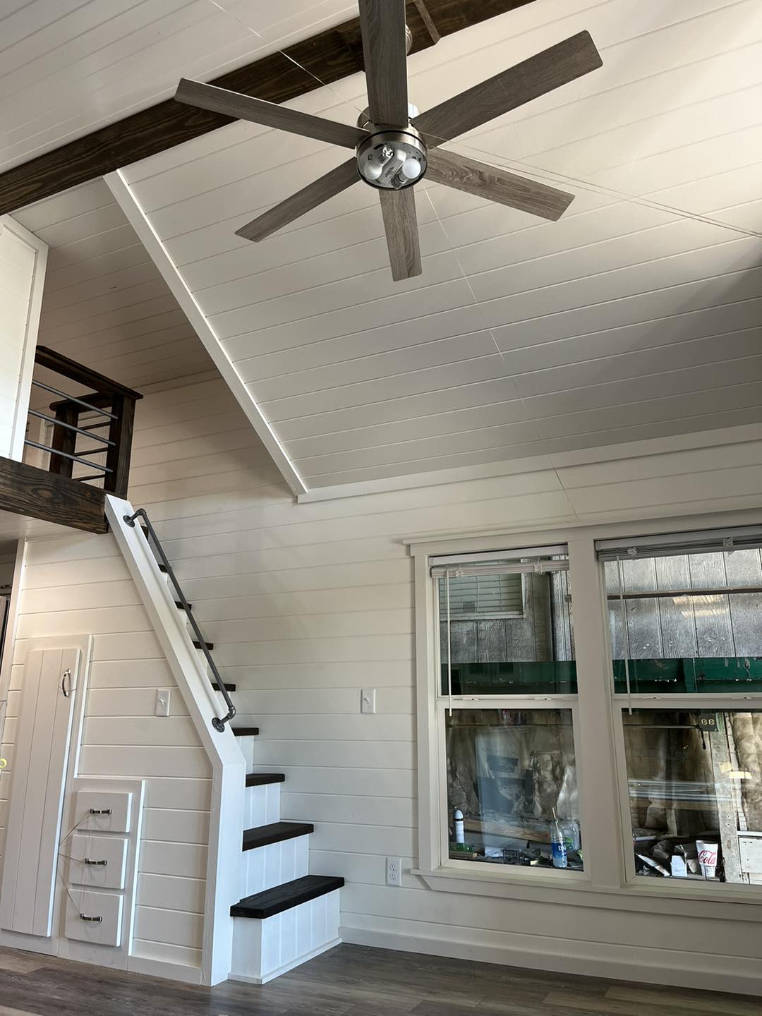 ACC-02 — vaulted living room with designer ceiling fan and loft above