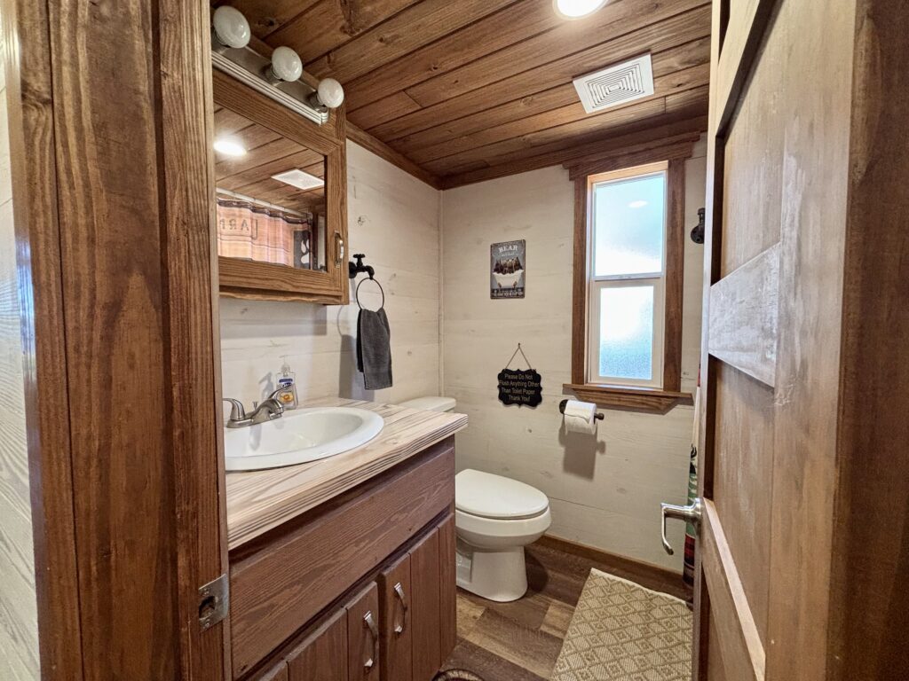 ACC-04 — full bathroom with vanity and window